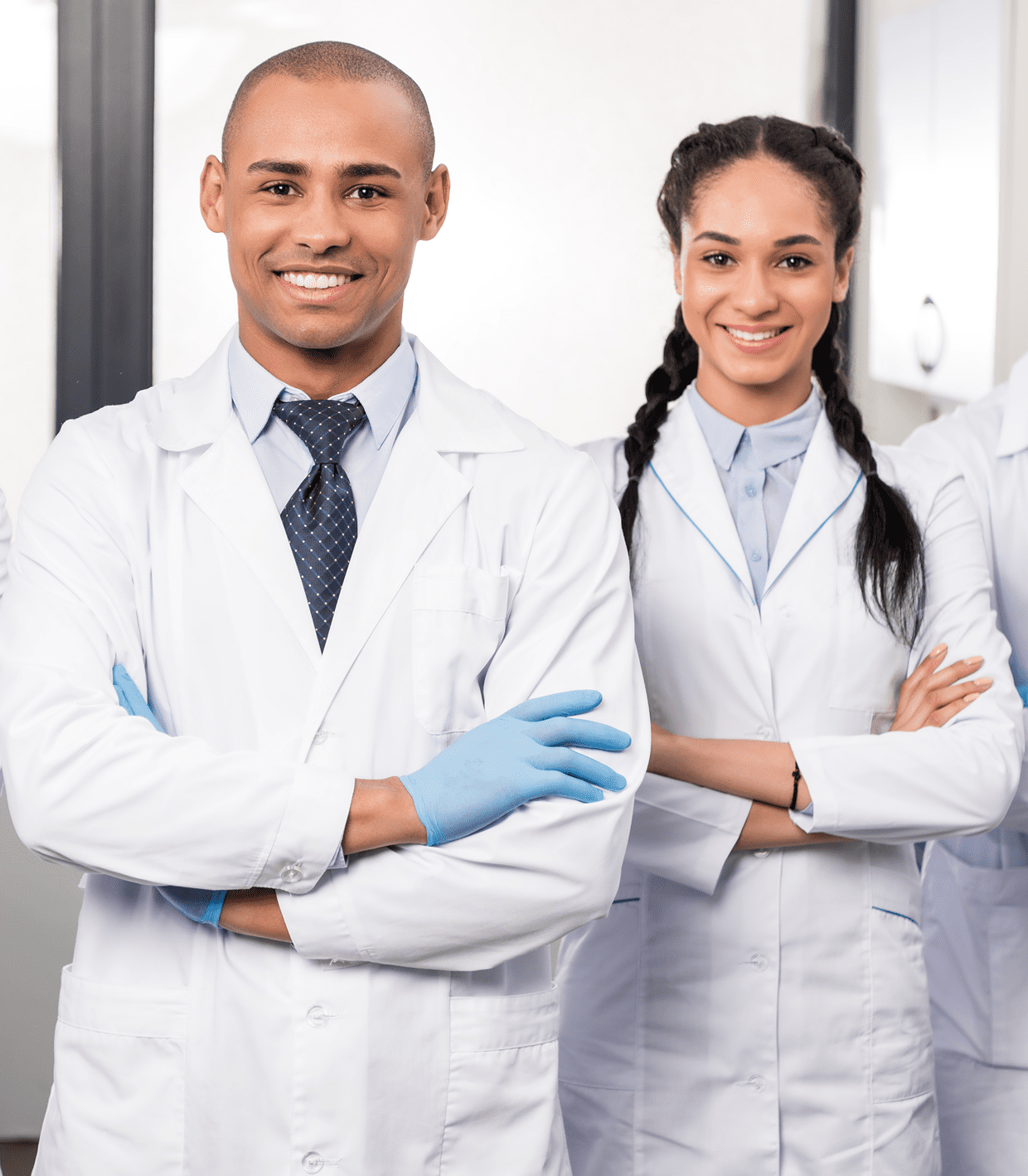 Smiling medical professionals in white lab coats.