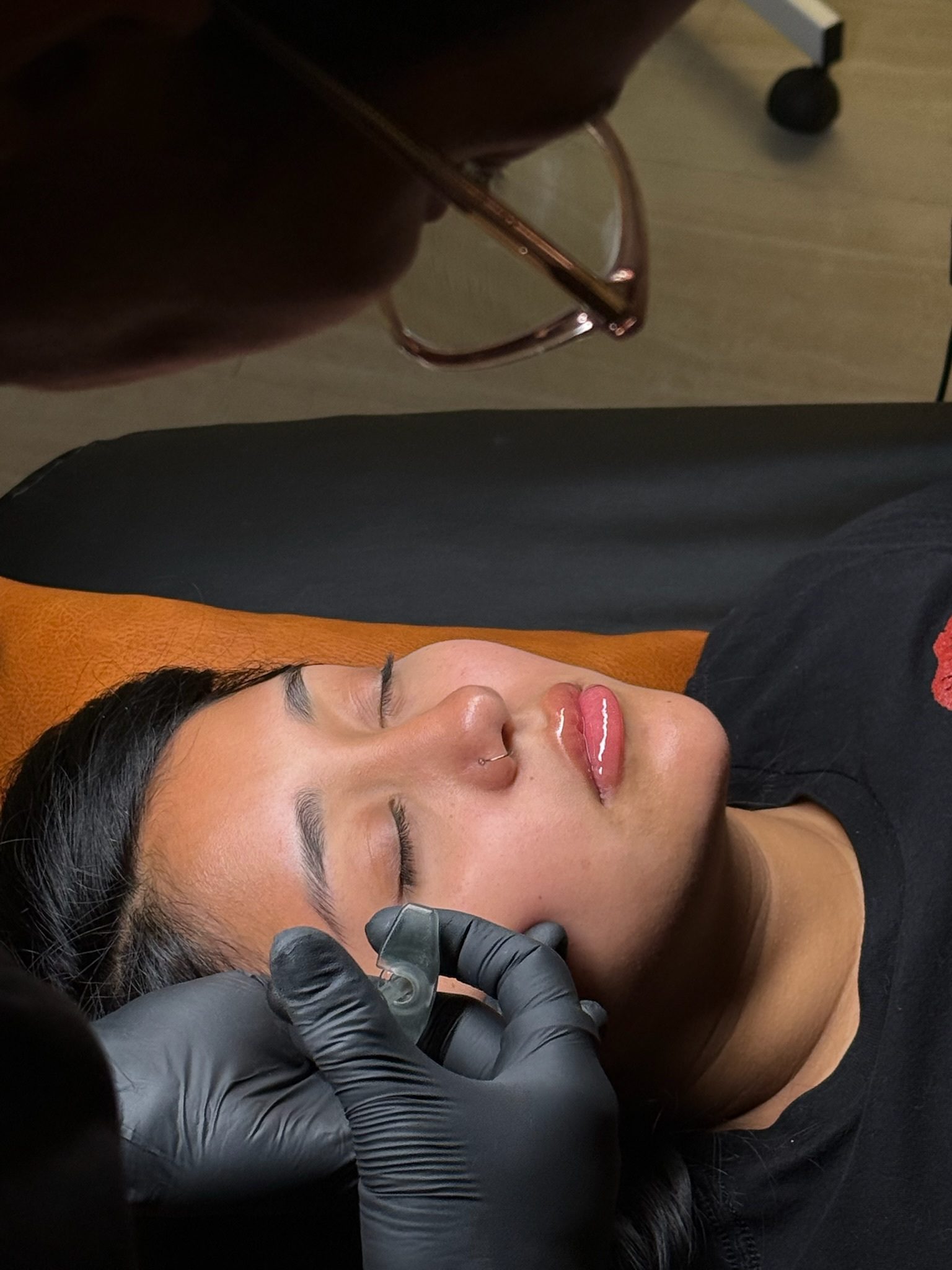 A person receiving a cosmetic tattoo on their lip.
